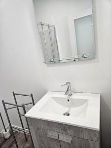 a bathroom with a white sink and a mirror at Ericeira Ribamar Sea View Villa in Santo Isidoro