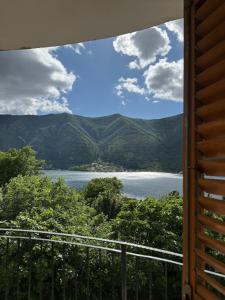 a view of a lake from a balcony at Sea and Mountain View - Cozy Pool Flat - Sleeps 6 in Dobrota