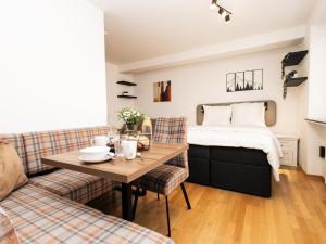 a living room with a bed and a table at Hoffie und Prost in Hopfgarten im Brixental