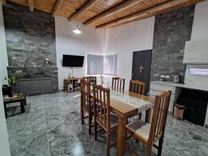 a dining room with a table and chairs and a fireplace at Casa Simón in San Rafael