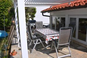 a table and chairs on the patio of a house at Sunny Cottage in Petrcane +50 photos