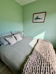 a bedroom with a bed with a blanket on it at Refugio del Pescador in Esquel +12 photos