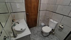 a bathroom with a white toilet and a sink at Casa Simón in San Rafael +22 photos