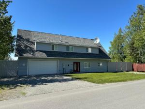a house with a garage and a fence at Downtown Wasilla Lakefront Home in Wasilla