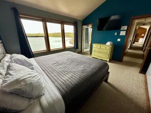 a bedroom with a bed and a large window at Downtown Wasilla Lakefront Home in Wasilla