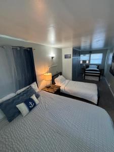a hotel room with two beds and a desk at Captains Cove in Port Clinton