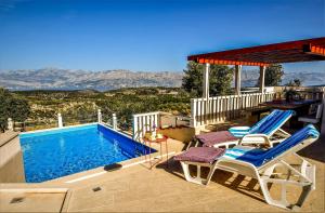 a patio with two chairs and a swimming pool at Family friendly house with a swimming pool Praznica, Brac - 24570 in Pučišća
