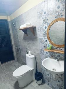 a bathroom with a toilet and a sink and a mirror at a Hue Homestay in Hue +51 photos