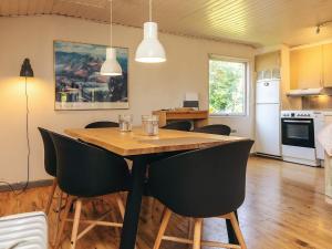 a kitchen and dining room with a table and chairs at 6 person holiday home in Bogø By in Bogø By