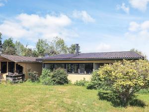 a house with a large yard in front of it at 6 person holiday home in Bogø By in Bogø By
