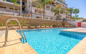 a swimming pool in front of a building at Stunning Apartment In Albuñol With Wifi in Albuñol +7 photos