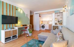 a living room with a couch and a tv at Stunning Apartment In Albuñol With Wifi in Albuñol