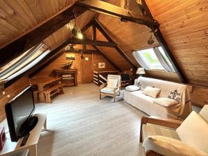 an attic living room with a couch and a tv at House in Brittany near Petit Havre Beach in Pordic