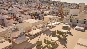 an aerial view of a city with tables and chairs at Hotel Indigo Albufeira by IHG in Albufeira