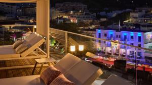 a balcony with a view of a city at night at Hotel Indigo Albufeira by IHG in Albufeira