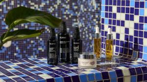 a group of bottles on a blue and white tiled table at Hotel Indigo Albufeira by IHG in Albufeira