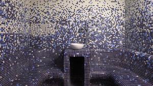 a bathroom with a blue and white tiled wall at Hotel Indigo Albufeira by IHG in Albufeira