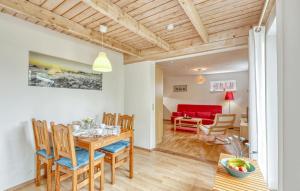 a dining room and living room with a table and chairs at Ferienhaus Dranske Nonnevitz in Nonnevitz