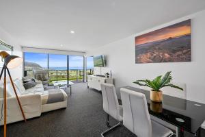 a bedroom with a bed and a desk with a television at Horizon Deluxe Apartments in Stanley