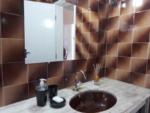 a bathroom with a sink and a mirror at Casa Verde Marinho - Sossego no Jacarecanga in Fortaleza +50 photos
