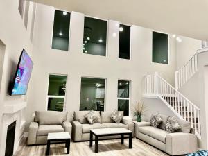 a living room with two couches and a fireplace at SINGLE HOUSE 1- Beautiful- Peaceful-4Beds 3baths- Sleeps 12 in Anchorage
