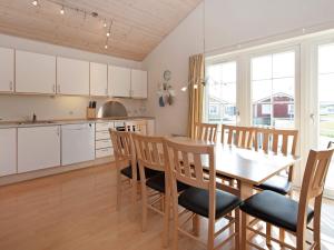 a kitchen and dining room with a table and chairs at 6 person holiday home on a holiday park in Gråsten in Gråsten