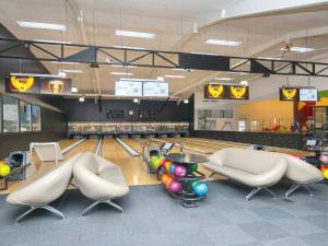 a bowling alley with pins and balls on the lanes at Type 10- Ho Holiday Centre holiday home in Blåvand