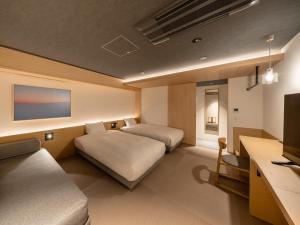 Letto o letti in una camera di Dansetsu Sapporo - Opening in Apr 2025