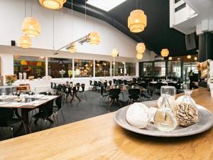 a table with a plate of food on top of a restaurant at Cozy 2-Person Apartment- Type 8 in Blåvand