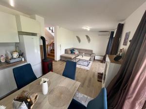 a dining table and chairs in a living room at Sarajevo Pine House in Sarajevo +42 photos