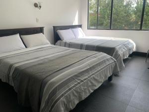 Postel nebo postele na pokoji v ubytování Latín Boutique