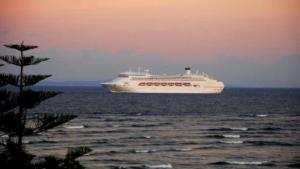 a cruise ship in the ocean at sunset at Esplanade View Unit 3 Wollombi in Caloundra