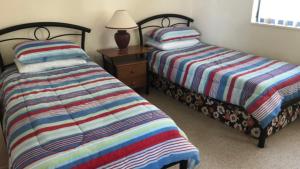 Postel nebo postele na pokoji v ubytování Sahara Sands Unit 4