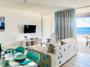 a living room with a couch and a table at Arthouse Sea View - Acquamarina e Zaffiro in Puerto del Carmen