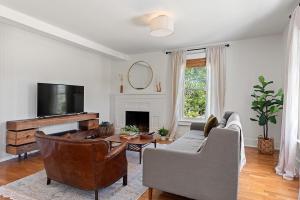 a living room with a couch and a tv at Sebastopol Farmhouse on 3 acres, fiber, kid friendly in Sebastopol