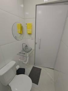 a bathroom with a toilet and a sink and a mirror at Studio CG 4, Campo Grande RJ in Estação Inhoaíba