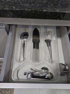 a drawer filled with utensils in a sink at Studio CG 4, Campo Grande RJ in Estação Inhoaíba