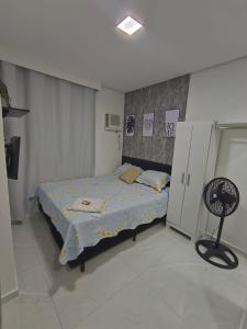 a small bedroom with a bed and a chair at Studio CG 4, Campo Grande RJ in Estação Inhoaíba