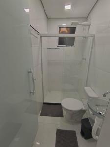 a bathroom with a shower and a toilet and a sink at Studio CG 4, Campo Grande RJ in Estação Inhoaíba