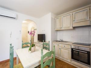 a kitchen with a table and chairs in a room at Apartment in Orosei near Marina di Orosei Beach in Orosei