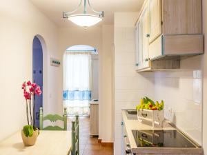 a kitchen with a bowl of fruit on the counter at Apartment in Orosei near Marina di Orosei Beach in Orosei +9 photos