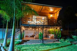 a house with a wrap around porch at night at Asmi Hill view in Jāmb