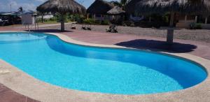 a large blue swimming pool next to a resort at Punta cerritos in Mazatlán