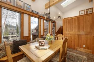 a dining room with a table and a couch at West Portal Cabin cabin in Grand Lake +37 photos