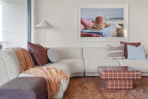 a living room with a couch and a chair at Caprina in Caloundra in Caloundra