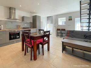 a kitchen and living room with a table and chairs at Maison rénovée avec WIFI et animaux admis, près de la Suisse Normande - FR-1-497-242 in Saint-Pierre-du-Regard