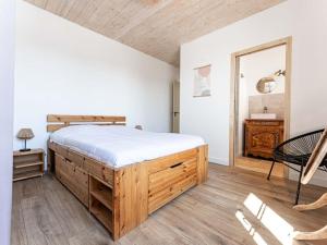 a bedroom with a large bed and a mirror at Maison moderne au Bois-Plage-en-Ré avec jardin - FR-1-835-3 in Le Bois-Plage-en-Ré +18 photos