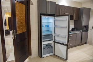 a refrigerator with its door open in a kitchen at Parkview Air B&B in Accra