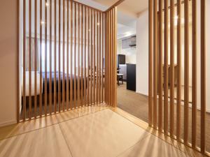 a room with a partition with a bed in the background at Minn Asakusa in Tokyo +2 photos