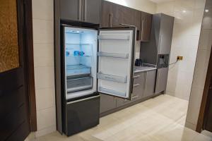 a refrigerator with its doors open in a kitchen at Parkview Air B&B in Accra